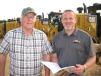 Ricky Callaway (L) and Daniel Lawrence, both of Yancey Bros. CAT, check out the sale schedule. 