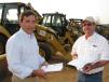 Phillip Pouncey (L) of Phillip Pouncey Builder Inc., Montgomery, Ala., and Randy Davison of R & J Grading Services, Hortense, Ga., compare notes on the backhoe loaders. 