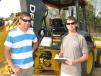 Mark (L) and Michael Clemmer, both of Clemmer Excavating, Newbern, Ala., show interest in some backhoe loaders in the sale lineup. 