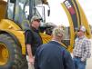 Barry Ferrell (L), Hydrema regional sales manager, addresses Power Equipment Company customers about the features of the Hydrema 922HM articulated truck. 
