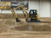 The operator of this Cat 308E2 mini hydraulic excavator with variable-angle-boom (VAB) demonstrates the possible use of this machine if it were equipped with a mower attachment.  
 