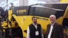 Sergio Solis (L) of Bomag and Bob Joynt, Finkbiner Equipment Co stand in front of the Bomag BM1200-35 milling machine.
 