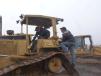 Mike Lynch (L) and Tony Nine of ProActive Equipment Solutions start up a Caterpillar dozer. 