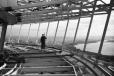 Photo: George Gulacsik/Seattle Public Library. In this photo from early December 1961, a worker is seen on the restaurant level of the Space Needle, with downtown Seattle in the background.
 