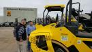 Brad Baum (L) of Stephenson Equipment speaks with Jeff Esbin of J.D. Eckman about the intelligent compaction built into the larger Bomag rollers. 