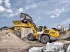 The manoeuvrable and dynamic Liebherr L 556 XPower wheel loader with industrial lift arms and high-dump bucket in test operation at a recycling business. 