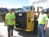 Derek Haas (L) and Steve Schneider, both of Haas & Son, prepare to take a look at the engine of this Cat 277D track skid steer.
 