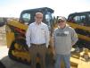 Chris Kline (L), Fabick CAT, shows this Cat 249D track skid steer to Jule Moss of Moss Contracting.
 