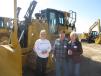 (L-R): Sue Perry and Walter and Rosemary Huse, all of Walter Huse Bulldozing, look at this Cat D6T LGP dozer.
 