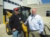 Marc Ericson (L) of Ericson Forrest Products speaks with Aaron Graveen, Fabick CAT, about this Cat 262D skid steer.
 