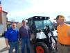 (L-R): Jay Kockler, general manager of Farm-Rite, St. Cloud Minn.; Kelly Schefers, owner of Schefers Excavating, St. Cloud, Minn.; and Jeff Ettel look over this Bobcat Toolcat 5600. 
 