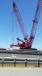 The crane is positioned on a leveling platform,  