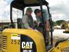 Dave Johnson (L) of Johnson Farms, Brighton, Tenn., gets a few pointers on maximizing operation time on a Cat 303.5E2 mini-excavator from Michael Miller of Thompson Machinery. 