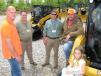(L-R): Chris Williams, Curb Appeal Tree Service, Hernando, Miss.; Sid Bounds and Michael Miller, Thompson Machinery; and Chris Jones and Ava Williams, also of Curb Appeal Tree Service, get an up-close look at Cat compact track loaders. 