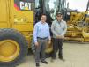 Edgar Sierra (L) and Mario Escobedo of Sika Construction in Monclova Coah, Mexico, are ready to take this Cat 140 M motorgrader home with them. 
 