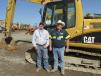 Casy Raitz (L) of U.S. Sand & Gravel in Stephenville, Texas, and Corky Underwood, RECS of Prosper, Texas, and inventor of the Bayonet Breaker, are deciding which of them will bid on this Cat 312 C excavator.
 