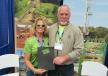 Amy Giovannone of Hartman & Hartman Inc., sponsors of the grand prize, presents Michael Cramer of the International Union of Operating Engineers, Local 18, with a certificate for a week’s cabin vacation in Deep Creek, Md.
 