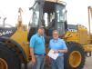 Colton and Brad Smith, both of R&R Construction, shop for a deal on a wheel loader. 
 