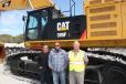 (L-R): John, Dan and Gary Pink stand in front of their new Cat 390F excavator. 
 
