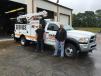 Chris Head (L) and Jarrett Kitchen stand in front of one of the two fully equipped service trucks based in Greenville. 