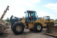 Greg (L) and Trevor Williams, Dirt Inc., inspect the Deere 544J wheel loader during the Saturday auction.” 