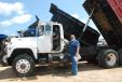 George Pittman (L) and Myles Mayo, both of Richton, Miss., take a seat in a Mack dump truck that was in the May 13 to 14 auction held in Brooklyn, Miss. 