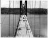 WSDOT photo.
Construction is under way on the 1940 Tacoma Narrows Bridge. Taken May 10, 1940, this photo shows roadway from the east side of the span. 