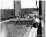 WSDOT photo.
Concrete work on the bridge — the bridge deck concrete was poured by large wheelbarrows. 