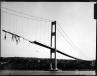 WSDOT photo.
A view of what was left of 1940 Tacoma Narrows Bridge after the Nov. 7, 1940 windstorm. While Galloping Gertie would gallop no more, this event changed forever how engineers design suspension bridges. Gertie's failure led to the safer suspension spans we use today. This photo shows the damaged side girder. 
