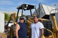 Bill Badilla (L) and Miguel Sanchez, both of Phoenix, Ariz., were interested in this Cat backhoe loader. 