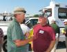 As the trucks roll out to start the auction, Ritchason Auctioneers’ Dewain Ritchason (L) talks with one of his regular customers, Brad Higgins of Dirtworks Unlimited, Chattanooga, Tenn. 
 