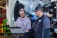 Justin MacDonald (L), a mechanic with Papé Kenworth — Redmond, goes over the service schedule for Central Oregon Truck Company’s Kenworth T680 with COTC maintenance shop foreman Travis Seeger.