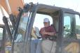 Gerard Dumsha of Go Away Acres Farm in Princess Ann, Md., checks out the controls on this excavator. 