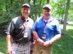 Mike Wilson (L) of Vectren talks with Jim Wilson of Miller Pipeline back at the hospitality house after walking the links 