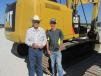 Thomas Holland (L) and his grandson, J.T., of Holland Dozers, Moran, Texas, have put this Cat 320E through its paces. 
 