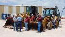 Customers patiently wait for the loader backhoes to be auctioned off. 
 