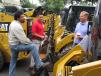Matt Chin (C) of Foley CAT discusses Caterpillar skid steers with Gus Ramirez (L) and Steve Gattoni, both of Schnell Contracting, Freehold, N.J. 