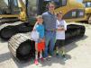 Grant Dixon (C), Providence Equipment of Athens, Texas, and his two sons, Mac (L) and Mitchell, were looking over this Cat 320C excavator.   
 