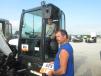 Ray Selke (R), owner of Rays Excavating, and his son, Devin, inspect this Bobcat compact excavator. 