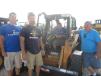 (L-R): Dave and Tony Zell, Basil Hicks and Ray Cantore gather around this Case SV 300 skid steer that they just purchased.
 