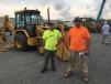 Blake Toombs (L) and Andrew Barton, both of All-N-Logging in Drakes Branch, Va., show interest in this John Deere 310 backhoe. 