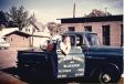 Palmer Peterson stands with a truck in 1960. 
