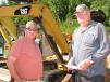 Barry Reese (L), Whitesburg, Ga., and Wayne Cole, Temple, Ga., retired contractors, look for a bargain on some compact machines. 