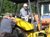 Jimmy Gray (L) and James Short of James Short Tractors & Equipment, Carnesville, Ga., test a  New Holland backhoe loader. 
