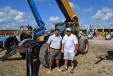 Antonio Ortiz (L) and Mike Reynolds, both of Ring Power, check out a few of the Cat machines at the auction. 