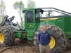 Dale Gessell, regional vice president of Nortrax, stands with a 848L grapple skidder. 
 