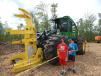 Gabe (L) and Logan Kiel check out a John Deere 843L feller buncher with a tree puller.
 