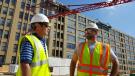 Darin D’Ascanio (L) of Stephenson Equipment and Dan Petrucelli of Lenick Construction discuss the delivery logistics and set up of the Potain T85A on the Hanover at North Broad Project job site. 