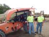Keith Posch (L), owner of Tri-Country Septic, Hollingsford, Minn., and Tanner Pierskalla, Tri-State, look at this JLG 600S lift.
