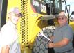 William (L) and Jeff Ratley, both of Jeff Ratley Trucking, Morganville, Ky., talk about this late-model Cat 950K wheel loader.